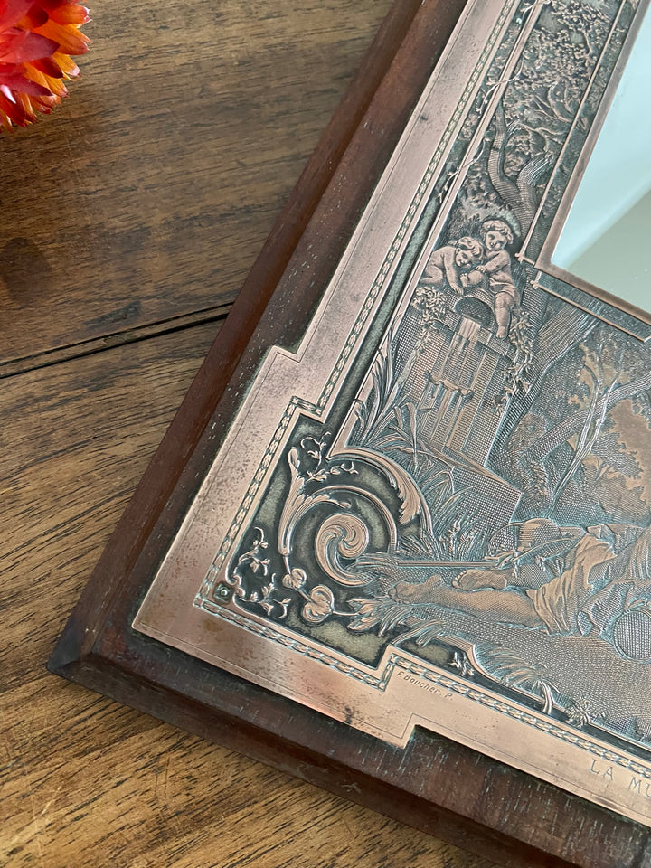 Miroir encadré bois décoré d'une plaque de cuivre