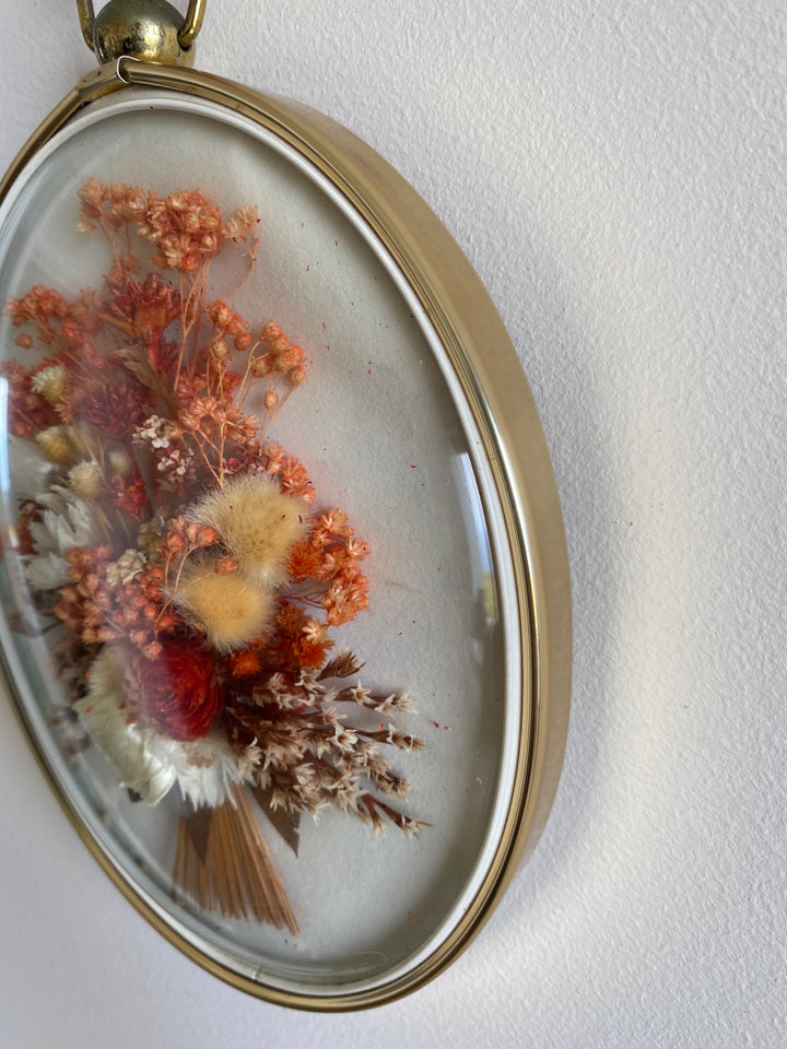 Fleurs séchées roses dans cadre bombé