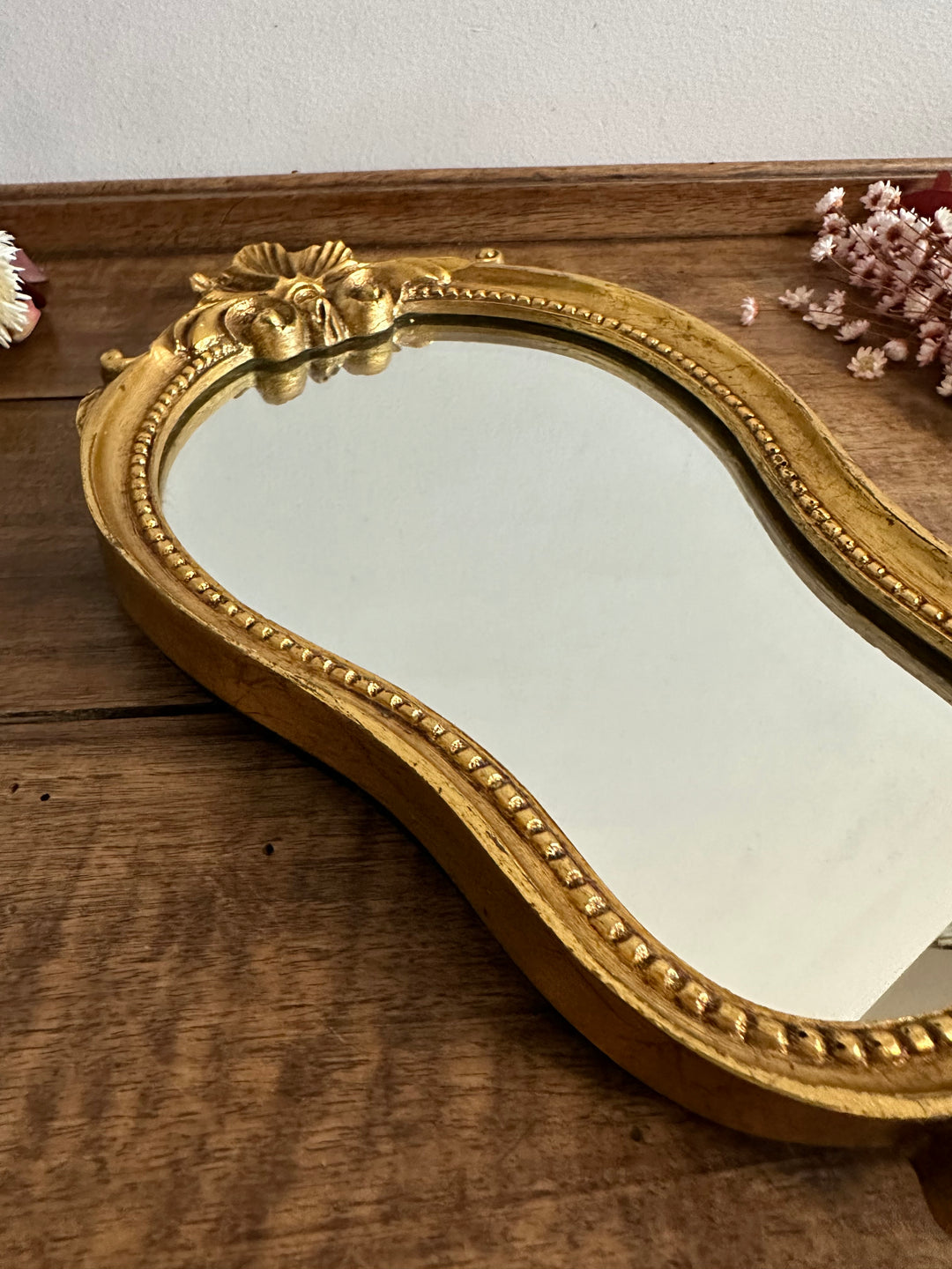 Miroir en bois et stuc fronton fleur doré à la feuille