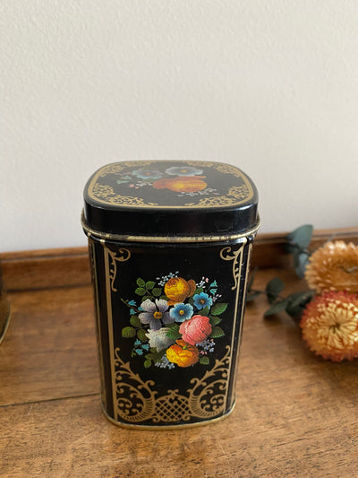 Boîtes à thé en métal fleurs sur fond noir craquelé