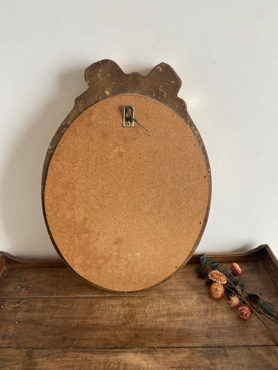 Miroir ovale en bois doré, style baroque avec nœud