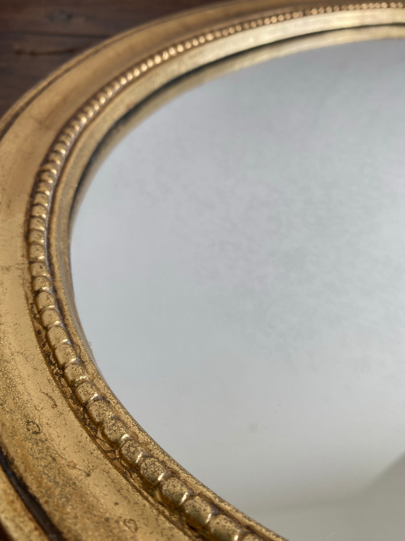 Miroir ovale en bois doré, style baroque avec nœud