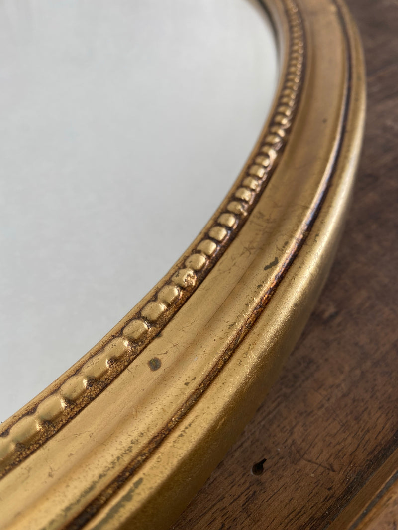 Miroir ovale en bois doré, style baroque avec nœud