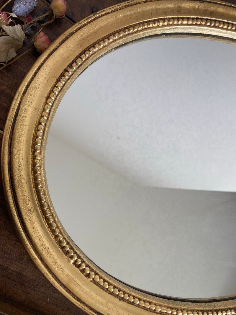 Miroir ovale en bois doré, style baroque avec nœud